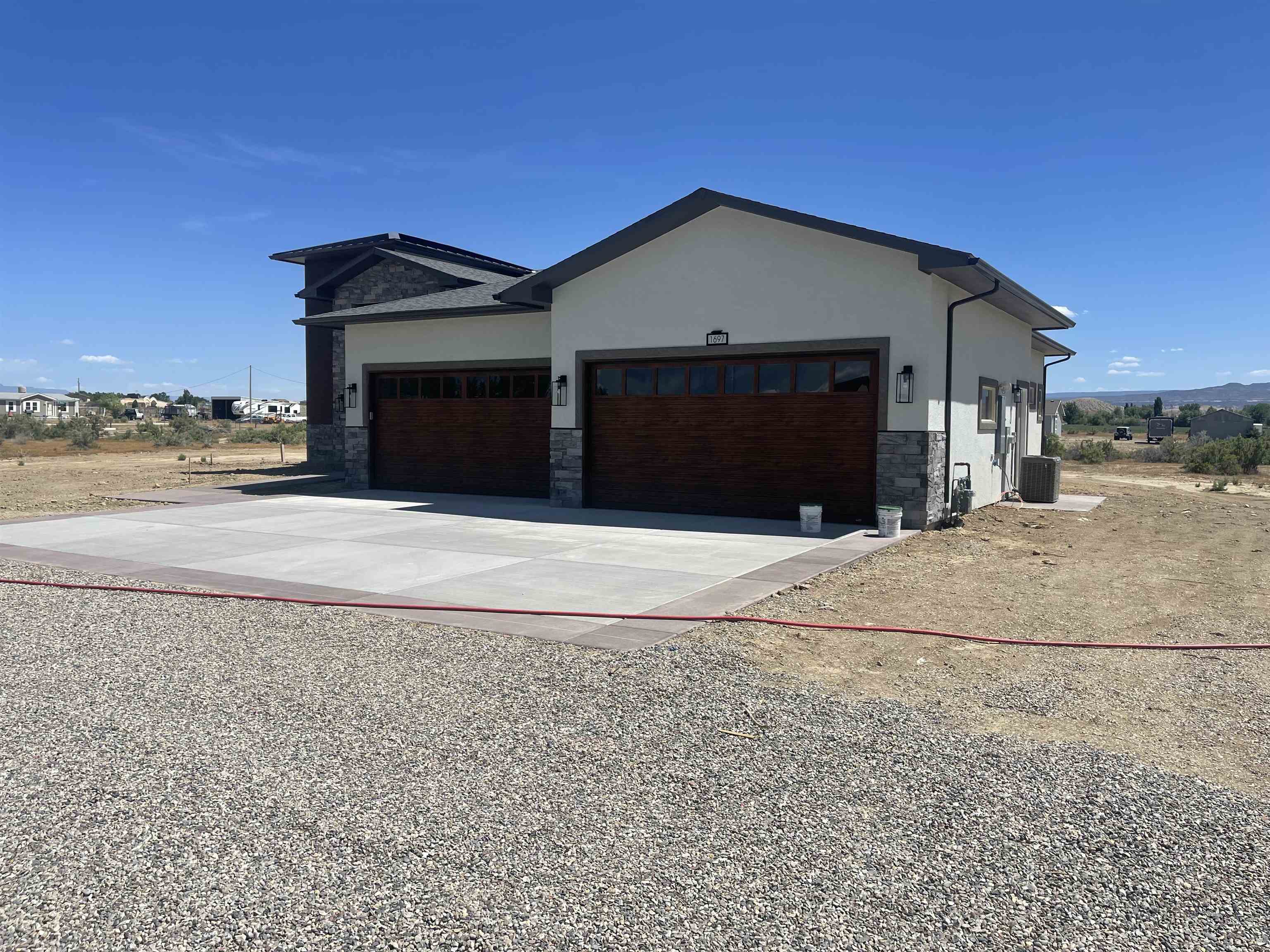 1697 P Road Loma, CO 81524 - Photo 33 of 39 a front view of a house with a yard and garage
