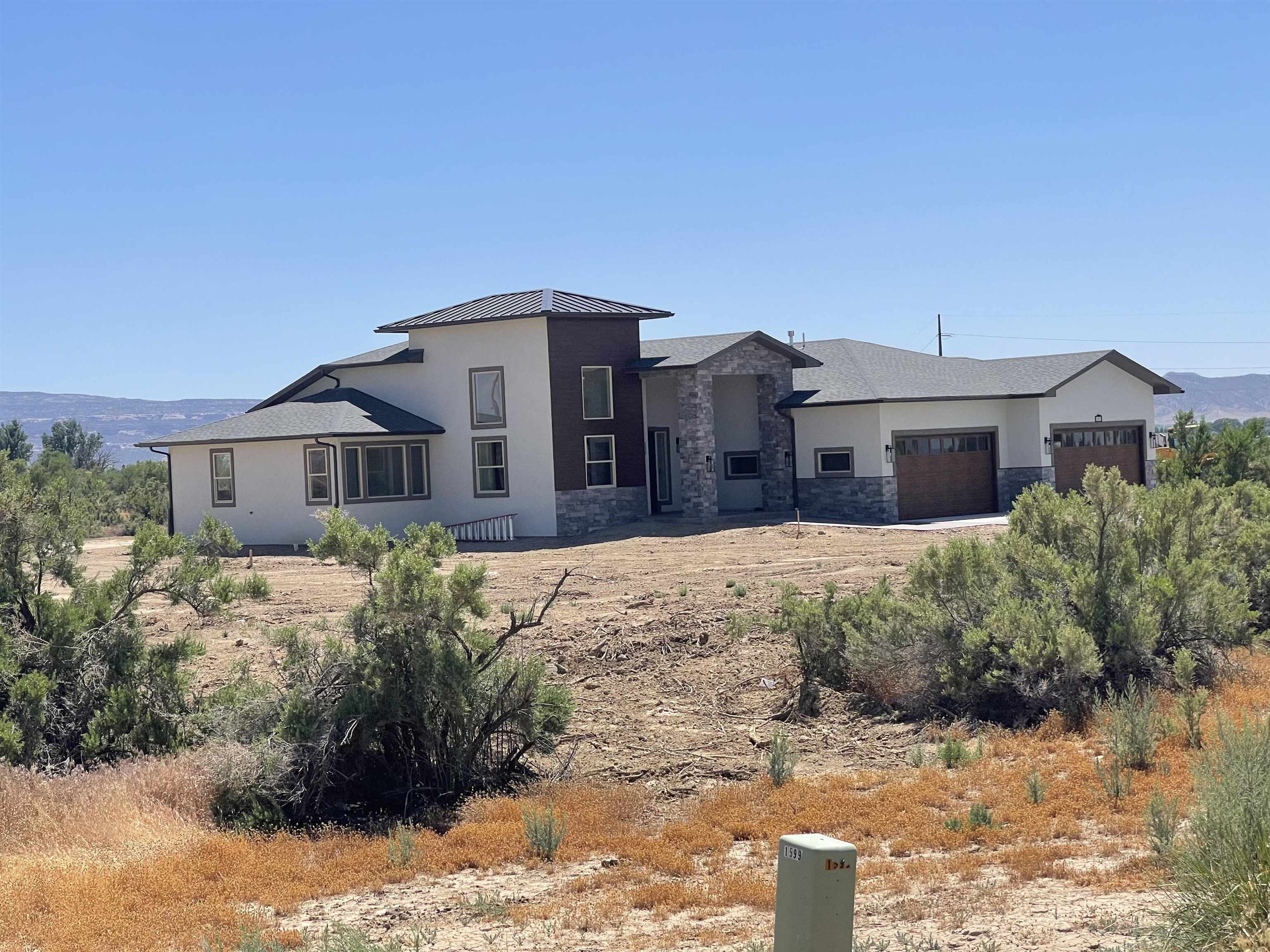 1697 P Road Loma, CO 81524 - Photo 36 of 39 a front view of a house with a yard