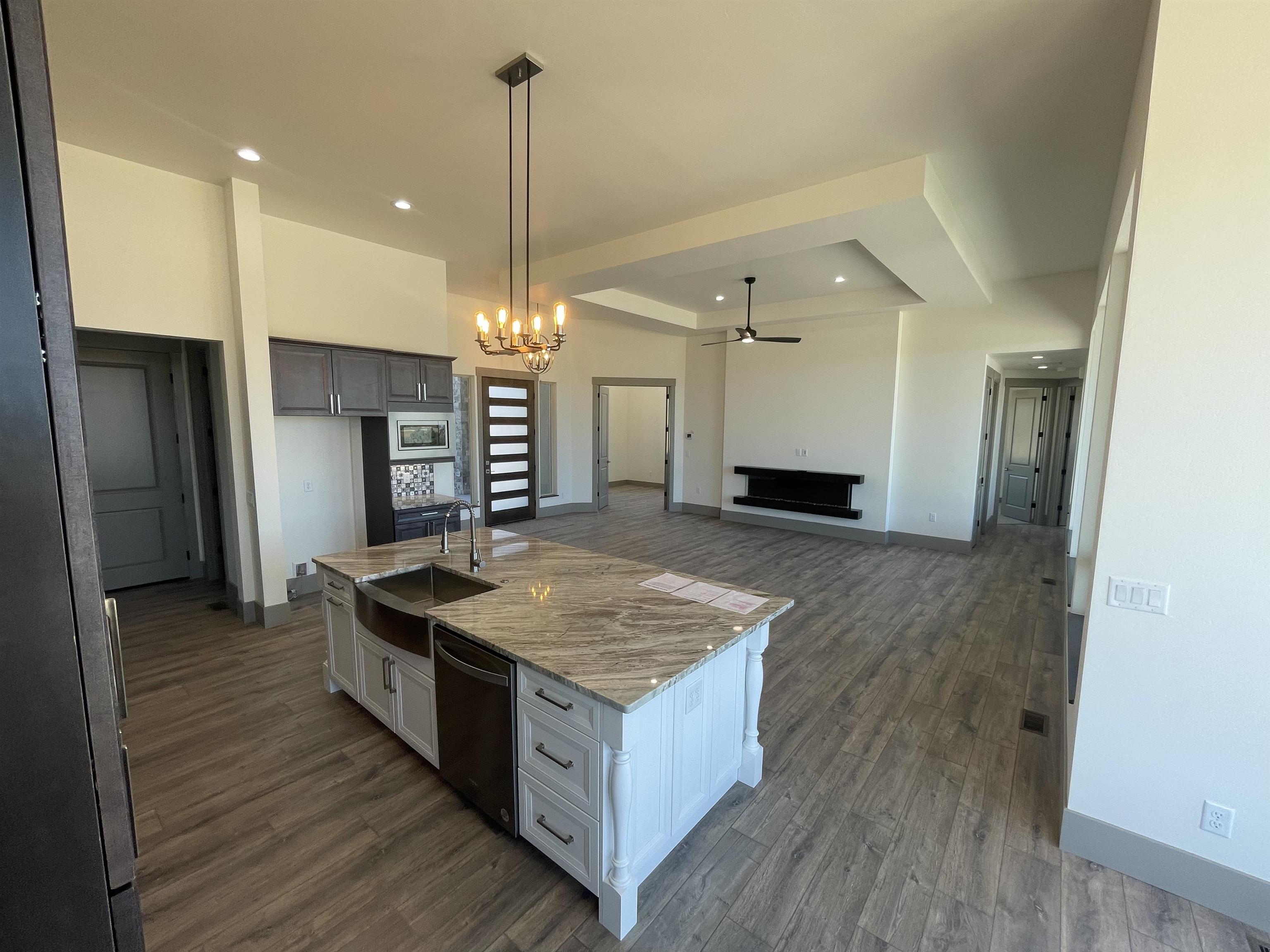 1697 P Road Loma, CO 81524 - Photo 7 of 39 a kitchen with kitchen island a counter top space a sink a refrigerator and a counter top space