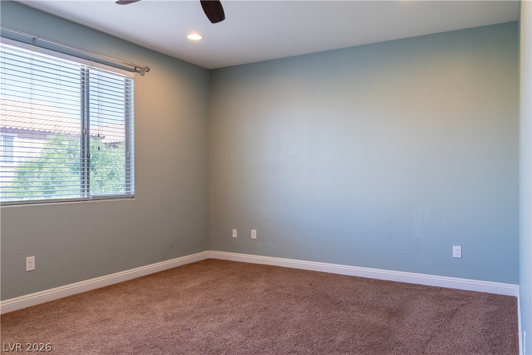 11045 Elk Sands Road Las Vegas, NV 89179 - Photo 55 of 67 Thick carpeting and smooth plaster walls define this versatile secondary bedroom space.