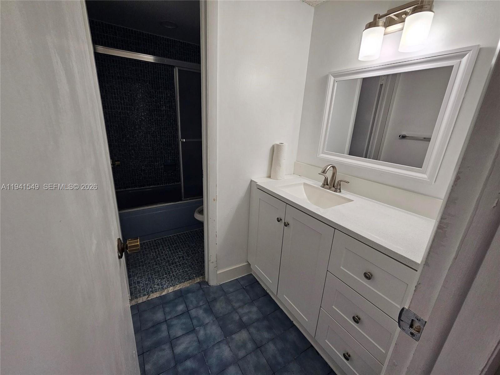 8990 Southwest 24th Street, Unit 228 Miami, FL 33165 - Photo 11 of 20 a bathroom with a sink and a mirror