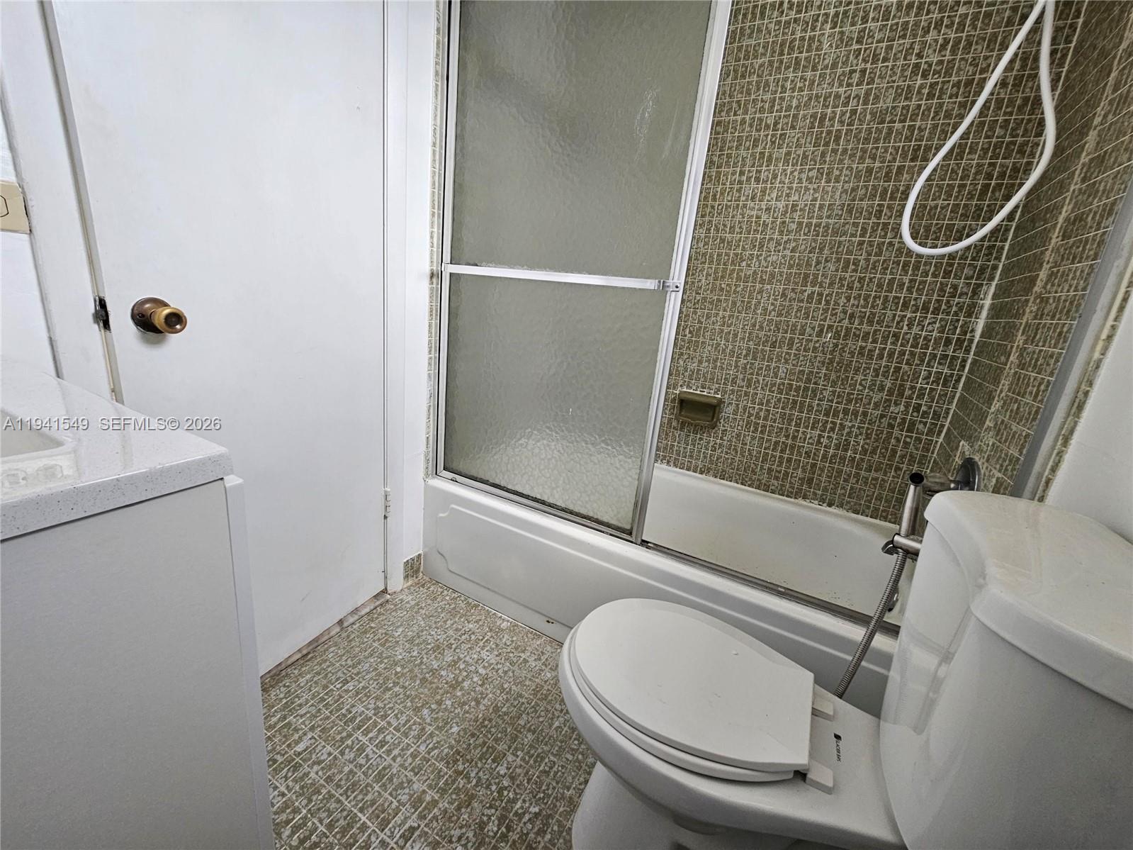 8990 Southwest 24th Street, Unit 228 Miami, FL 33165 - Photo 14 of 20 a bathroom with a sink a toilet and shower