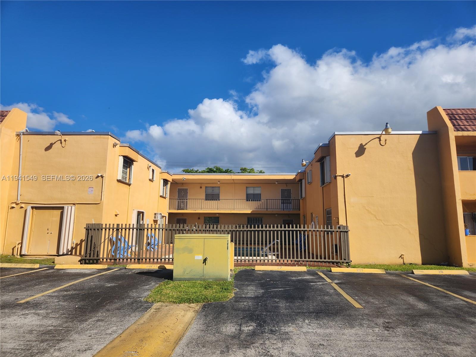 8990 Southwest 24th Street, Unit 228 Miami, FL 33165 - Photo 2 of 17 a view of a street with a building in the background