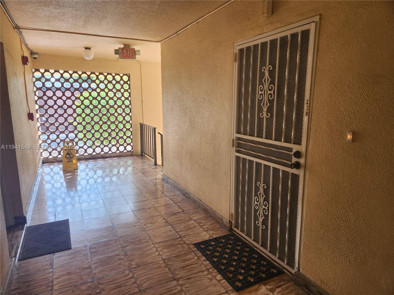 8990 Southwest 24th Street, Unit 228 Miami, FL 33165 - Photo 3 of 17 a view of a wooden door