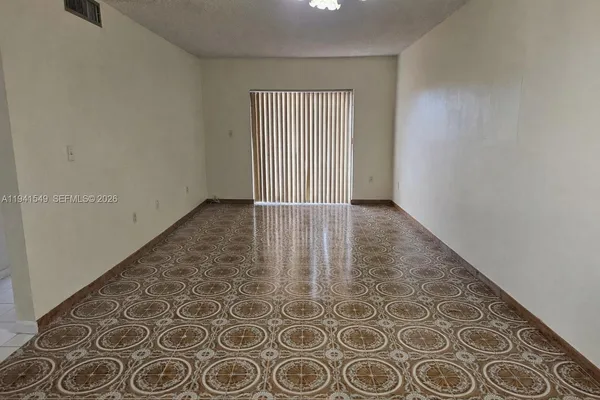 an empty room with wooden floor