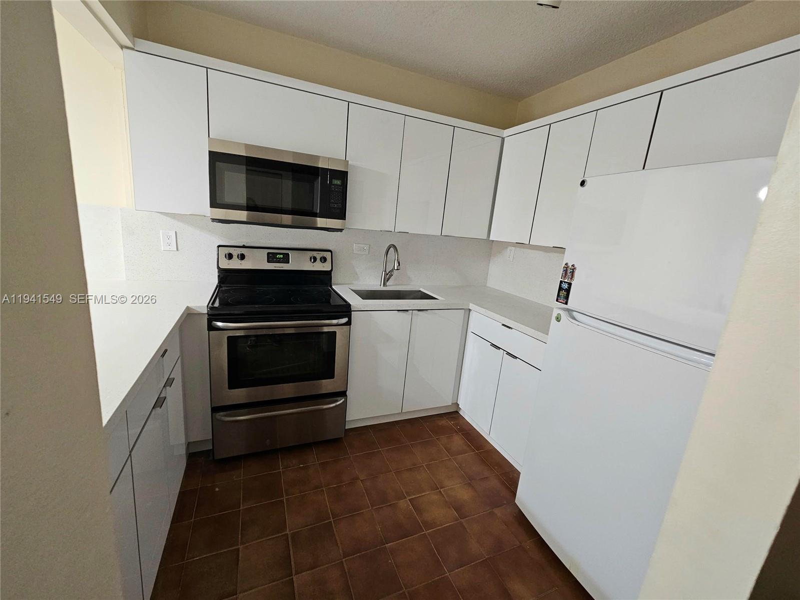 8990 Southwest 24th Street, Unit 228 Miami, FL 33165 - Photo 6 of 20 a kitchen with a sink and a stove