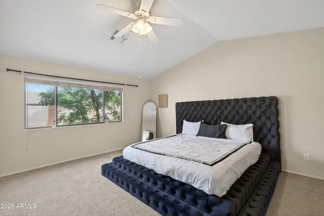 a bedroom with a large bed and a window