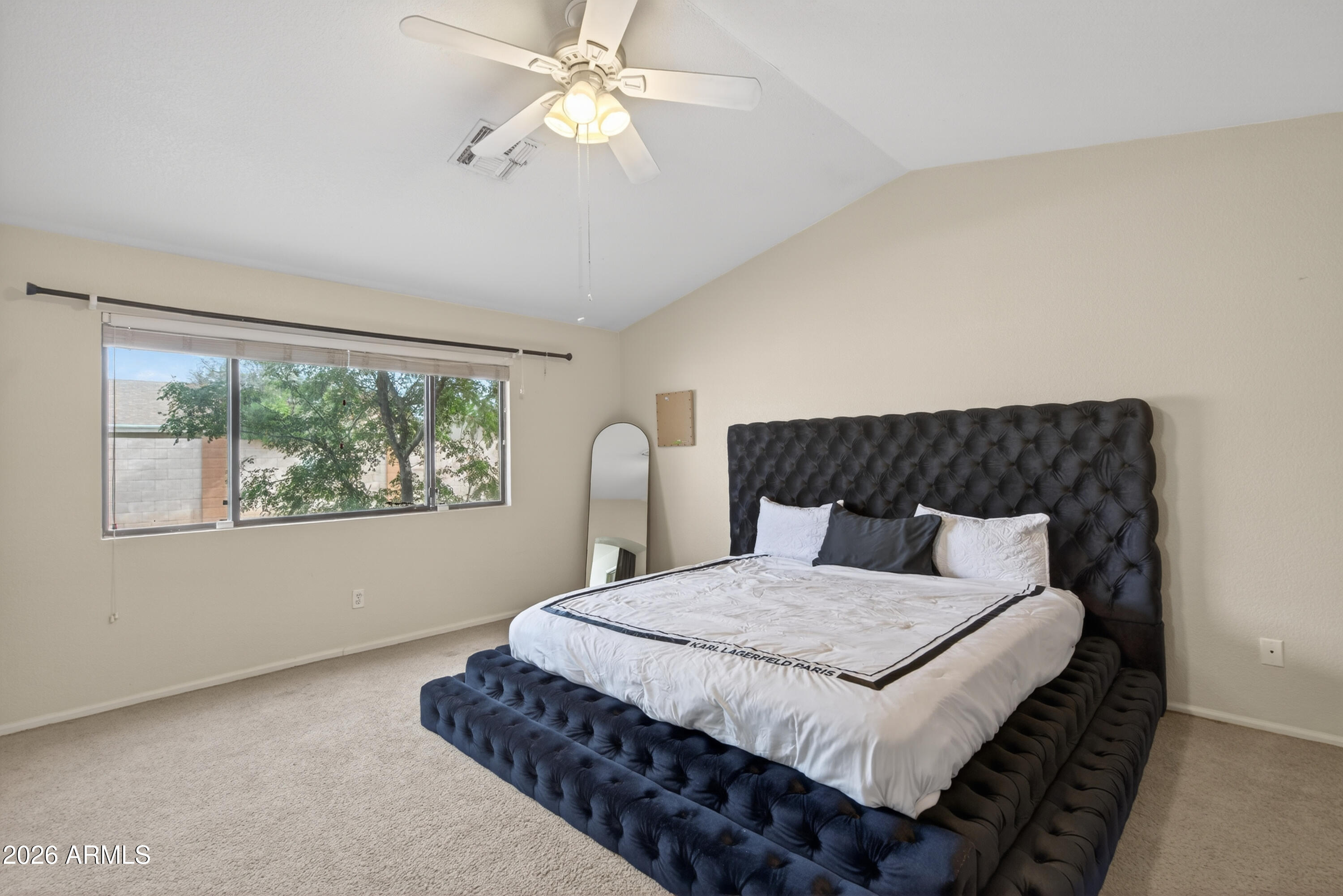 4547 North 87th Avenue Phoenix, AZ 85037 - Photo 11 of 22 a bedroom with a large bed and a window