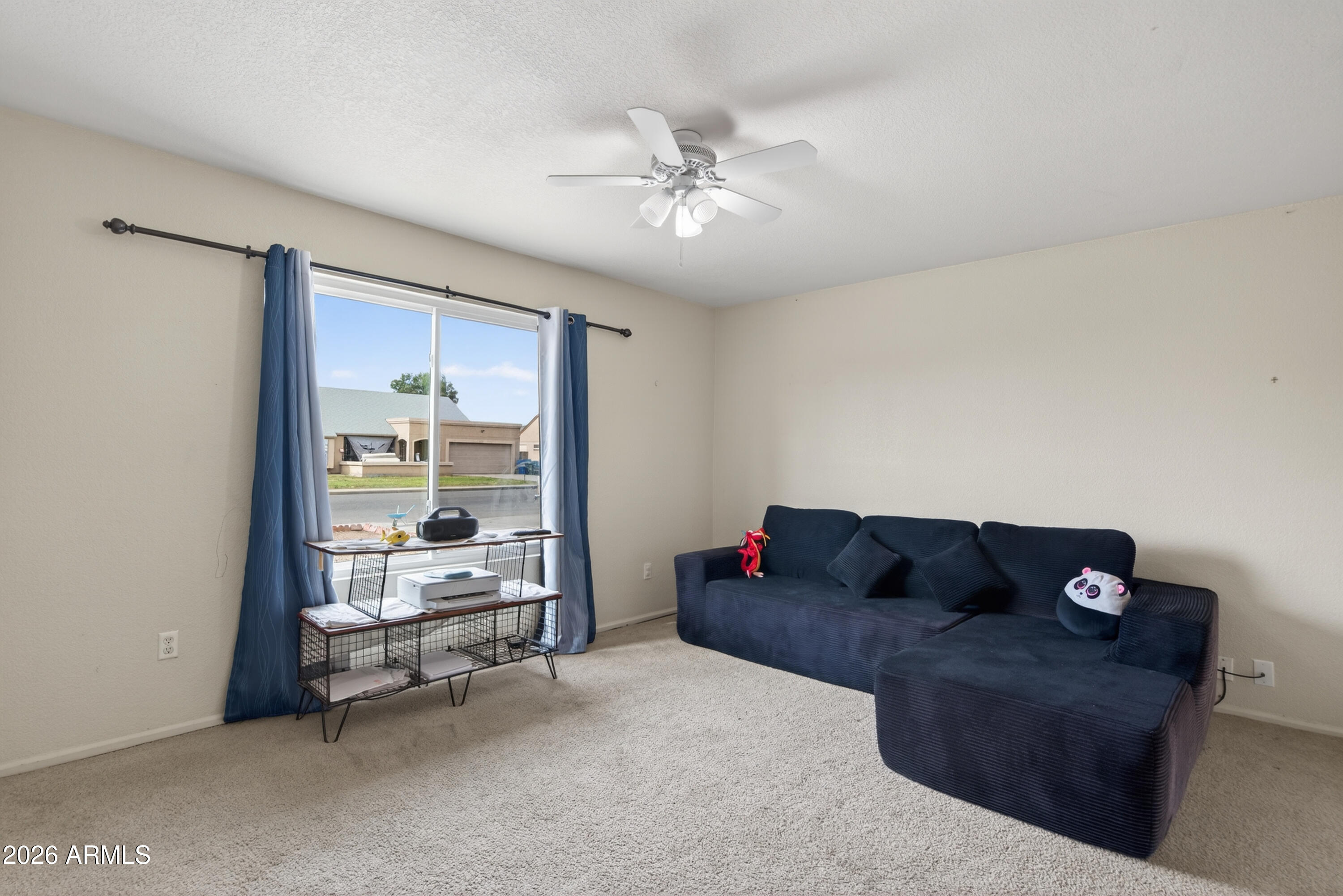 4547 North 87th Avenue Phoenix, AZ 85037 - Photo 14 of 22 a living room with furniture and a large window