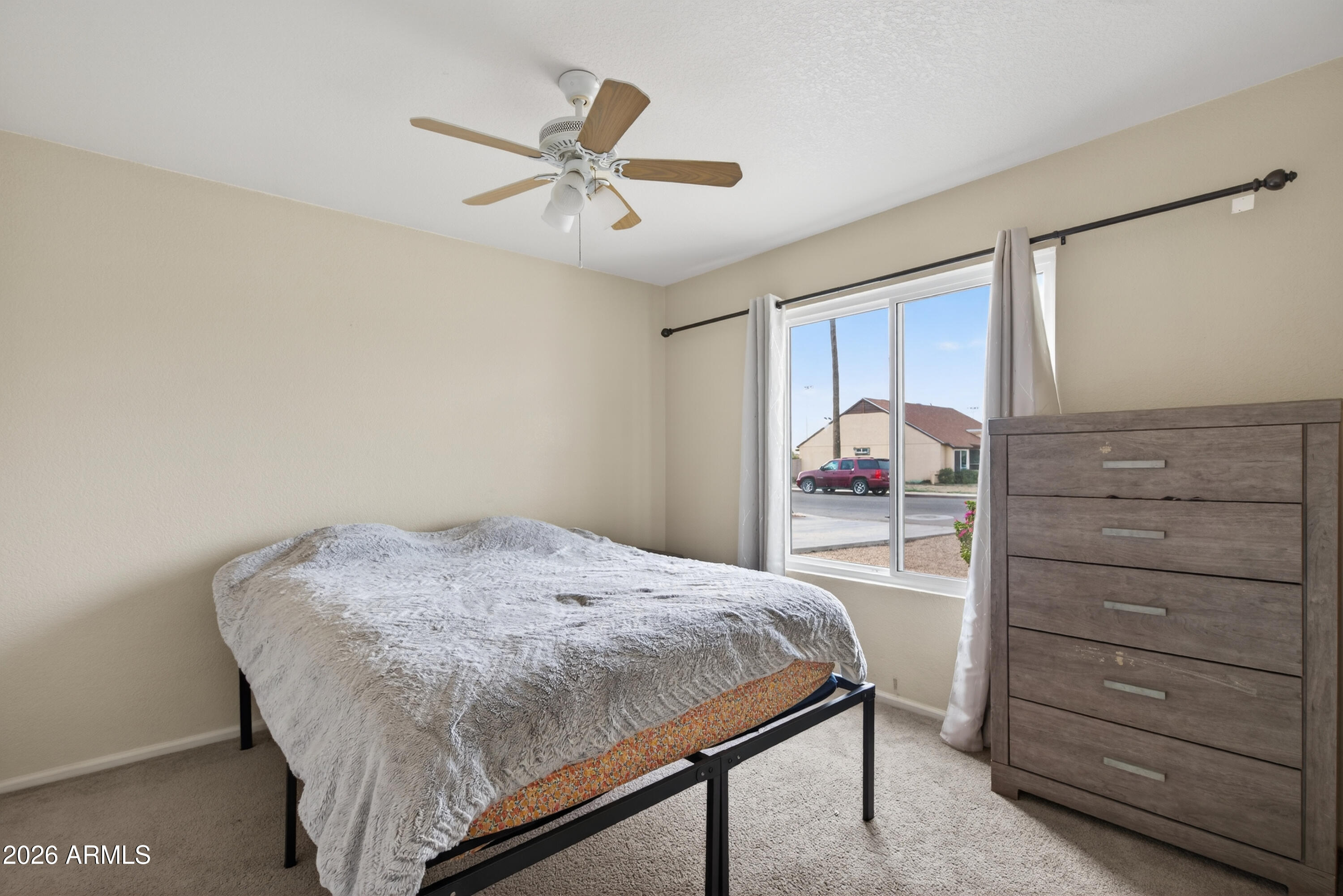 4547 North 87th Avenue Phoenix, AZ 85037 - Photo 16 of 22 a bedroom with a bed and cabinet