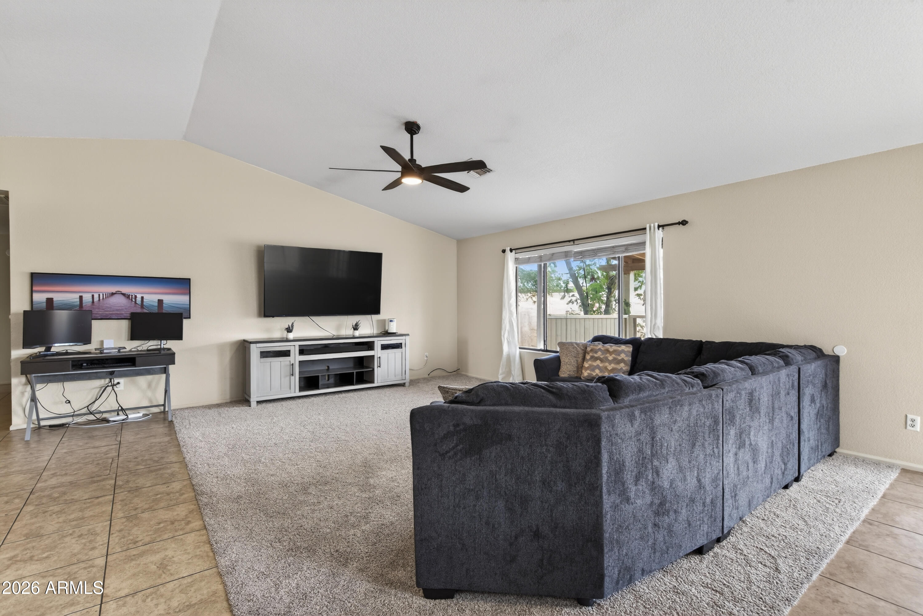4547 North 87th Avenue Phoenix, AZ 85037 - Photo 3 of 22 a living room with furniture and a flat screen tv