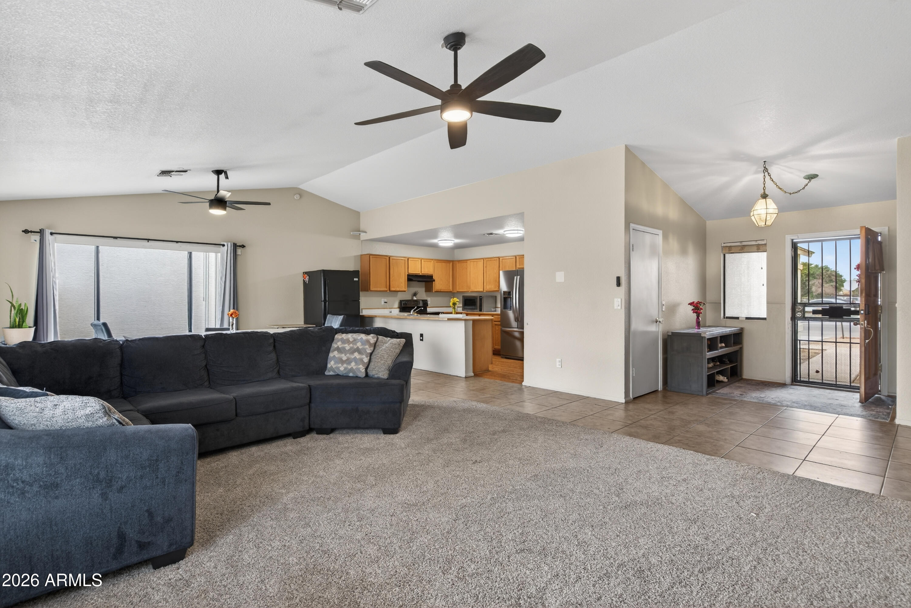 4547 North 87th Avenue Phoenix, AZ 85037 - Photo 4 of 22 a living room with furniture and kitchen view