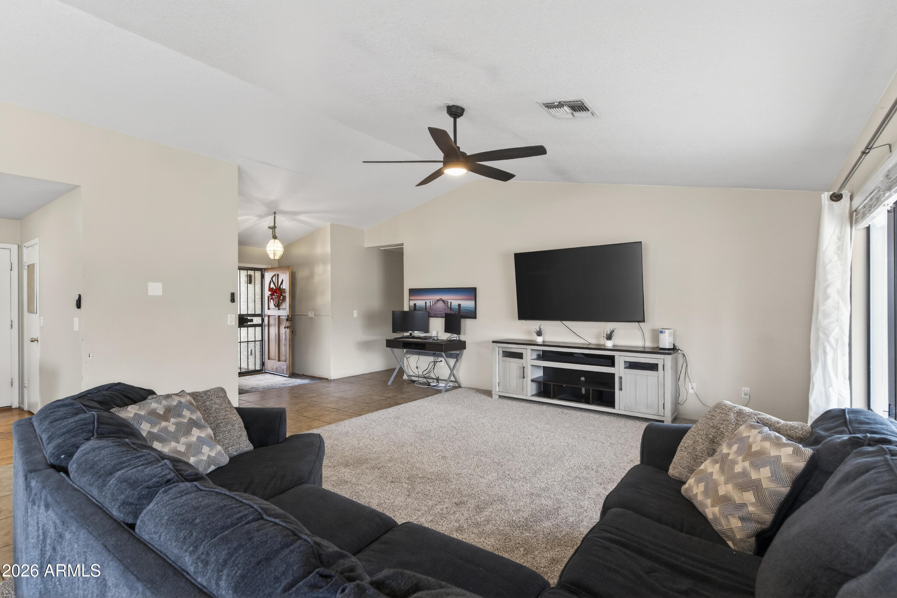 4547 North 87th Avenue Phoenix, AZ 85037 - Photo 5 of 22 a living room with furniture and a flat screen tv