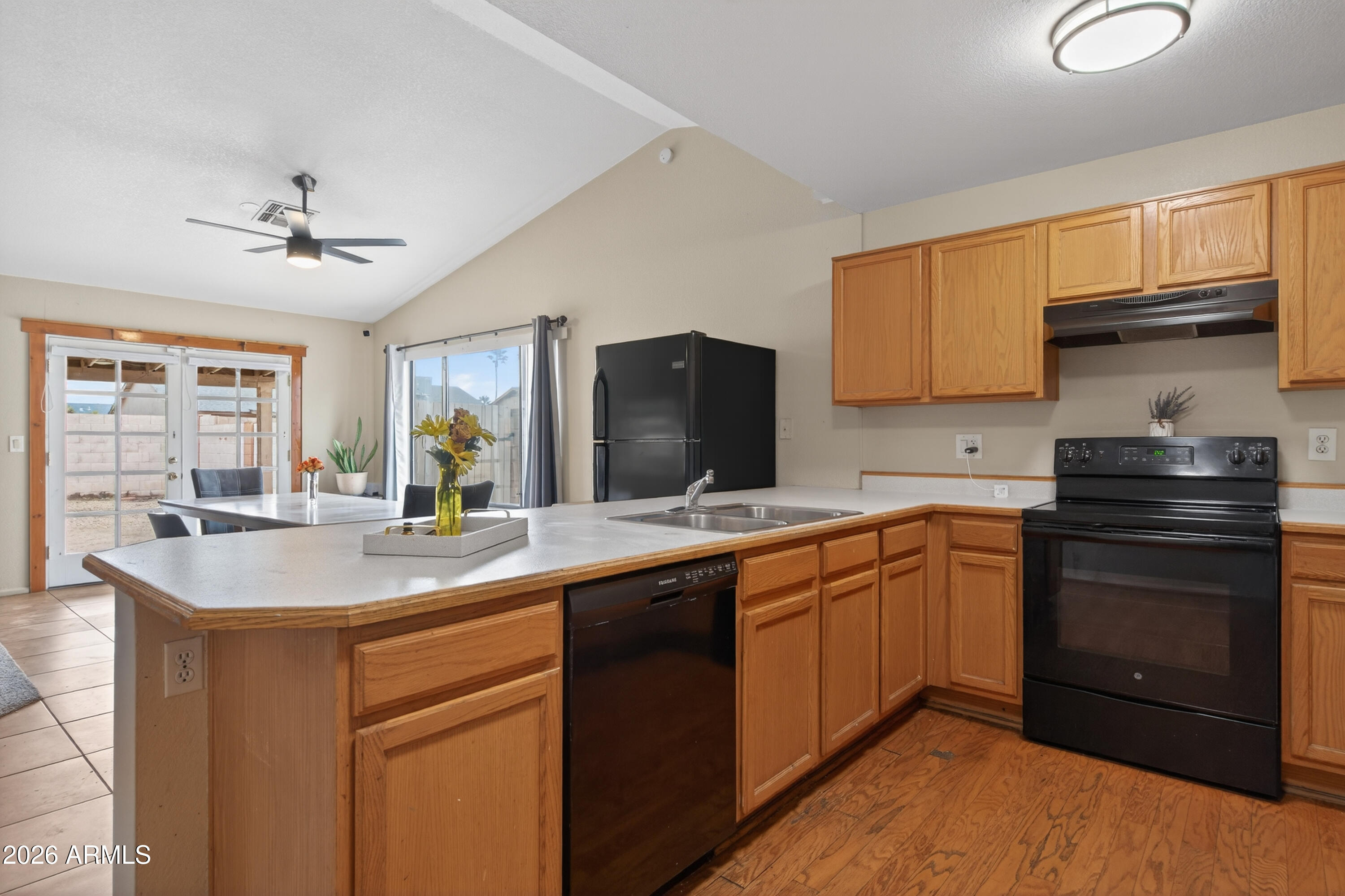 4547 North 87th Avenue Phoenix, AZ 85037 - Photo 8 of 22 a kitchen with stainless steel appliances granite countertop a sink stove and refrigerator