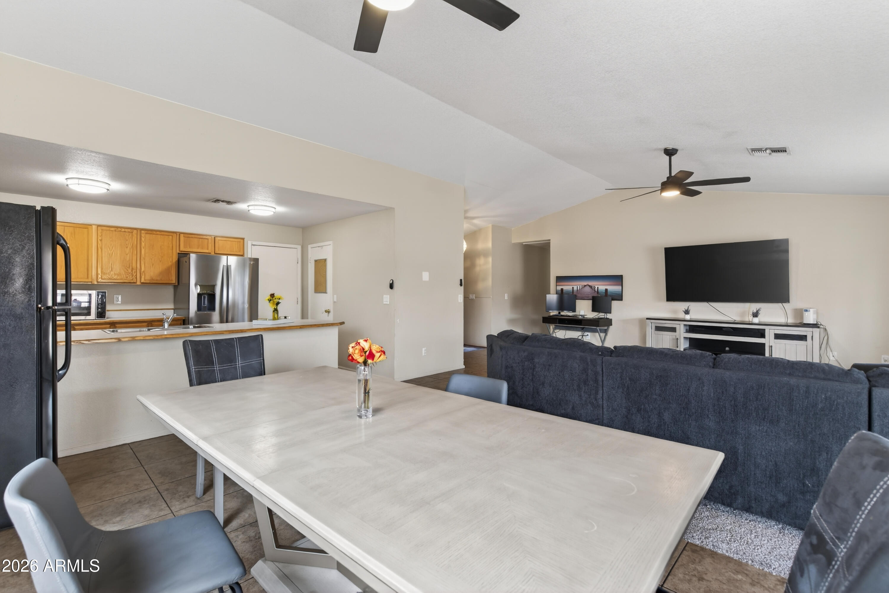 4547 North 87th Avenue Phoenix, AZ 85037 - Photo 10 of 22 a kitchen with stainless steel appliances a dining table chairs and granite counter tops