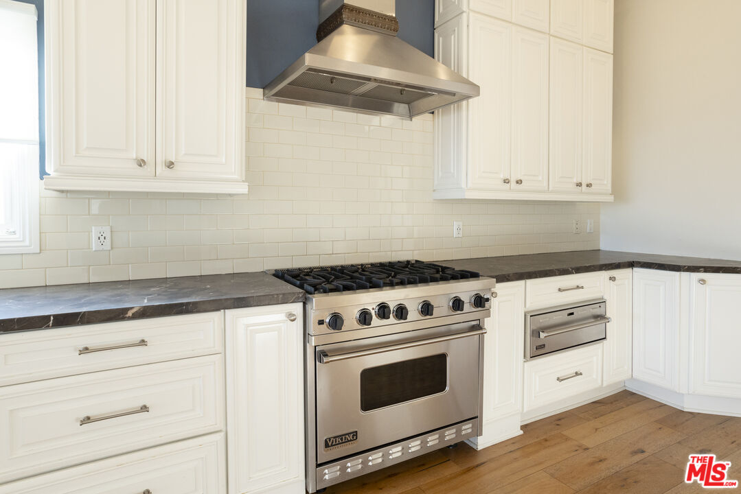 18436 Wakecrest Drive Malibu, CA 90265 - Photo 11 of 41 a white stove top oven sitting inside of a kitchen