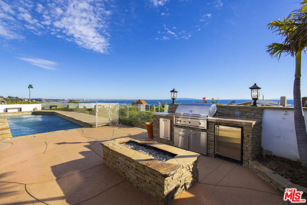 18436 Wakecrest Drive Malibu, CA 90265 - Photo 15 of 41 a terrace with a kitchen island