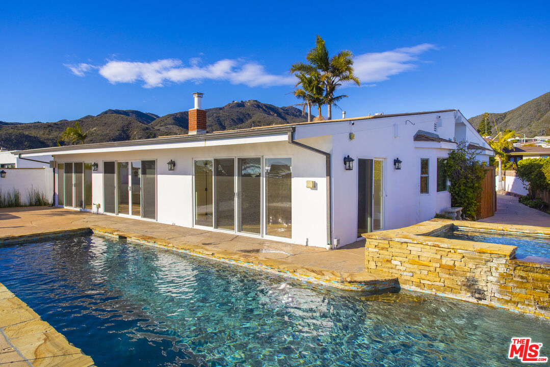 18436 Wakecrest Drive Malibu, CA 90265 - Photo 19 of 41 a front view of a house with a big yard