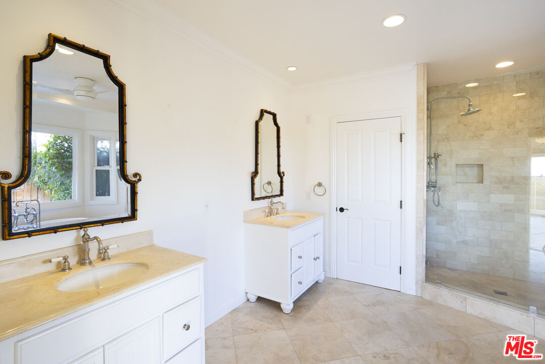 18436 Wakecrest Drive Malibu, CA 90265 - Photo 27 of 41 a bathroom with a double vanity sink mirror and shower