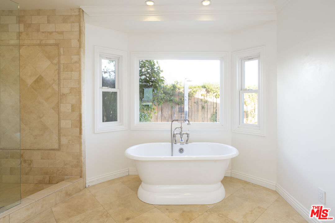 18436 Wakecrest Drive Malibu, CA 90265 - Photo 28 of 41 a white bath tub sitting in a bathroom next to a window