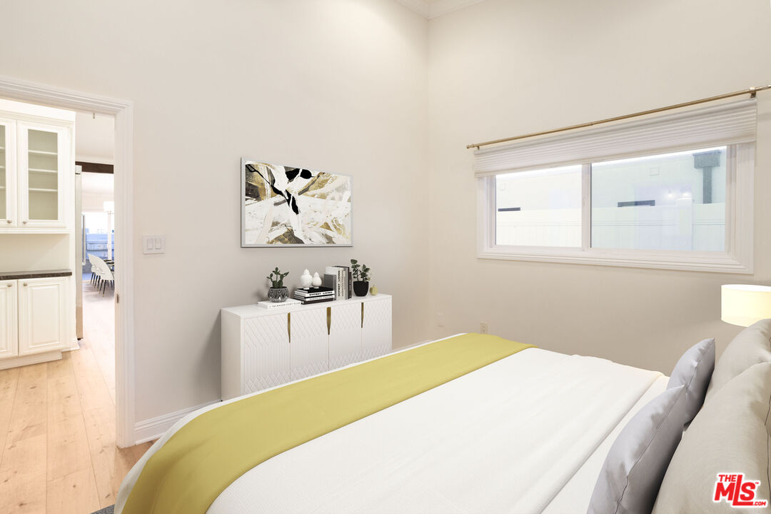 18436 Wakecrest Drive Malibu, CA 90265 - Photo 29 of 41 a bedroom with a bed and a chandelier