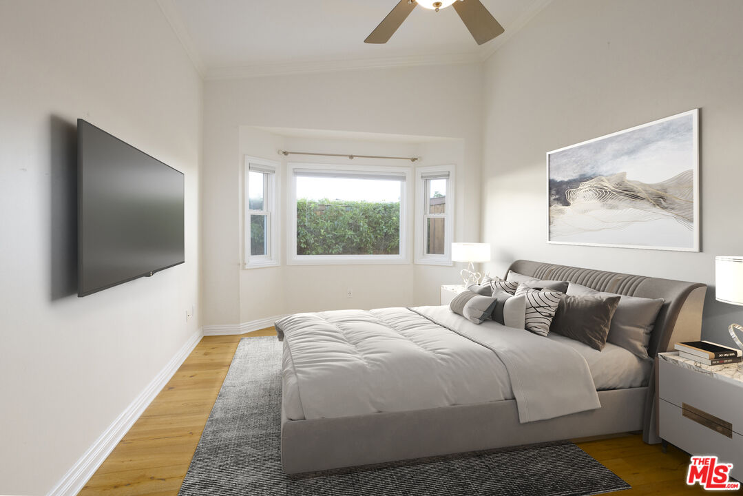 18436 Wakecrest Drive Malibu, CA 90265 - Photo 31 of 41 a bedroom with a bed and a flat screen tv