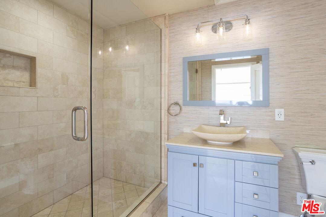 18436 Wakecrest Drive Malibu, CA 90265 - Photo 34 of 41 a bathroom with a sink shower and a mirror