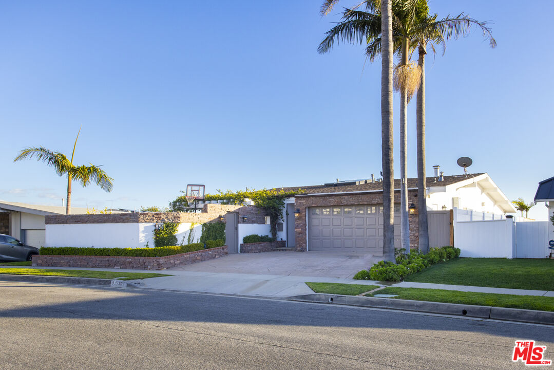 18436 Wakecrest Drive Malibu, CA 90265 - Photo 5 of 41 a front view of a house with a garden and trees