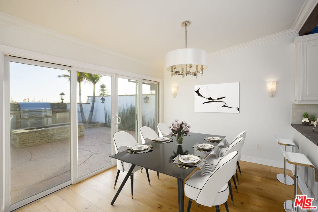 18436 Wakecrest Drive Malibu, CA 90265 - Photo 9 of 41 a view of a dining room with furniture a chandelier and wooden floor