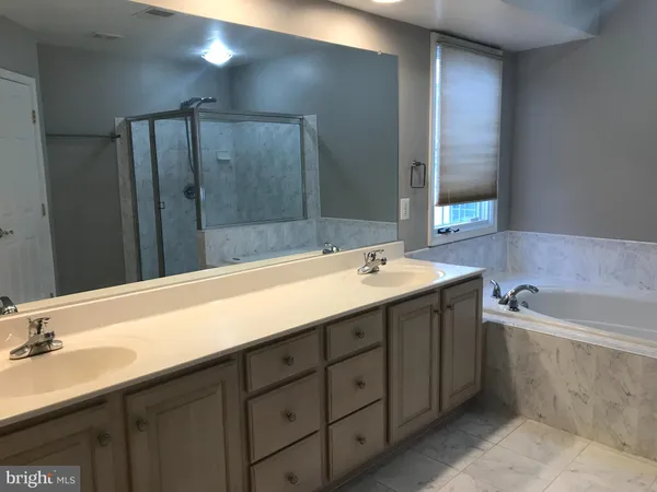 a bathroom with a bathtub and shower