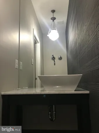 a bathroom with a sink and a window