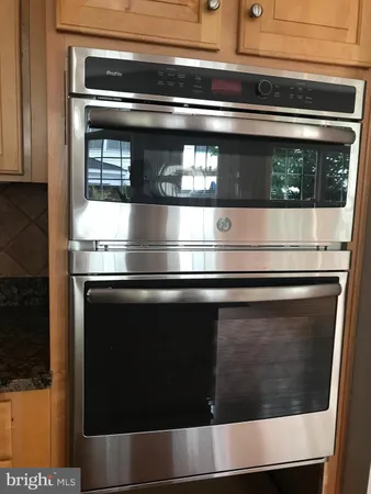 a stove top oven sitting inside of a kitchen