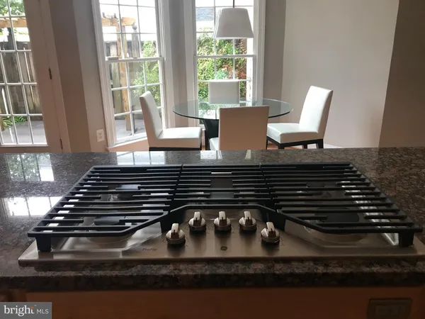 a kitchen with a stove and a white cabinet