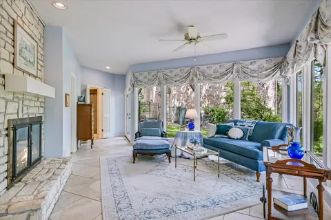 a living room with furniture and a floor to ceiling windows