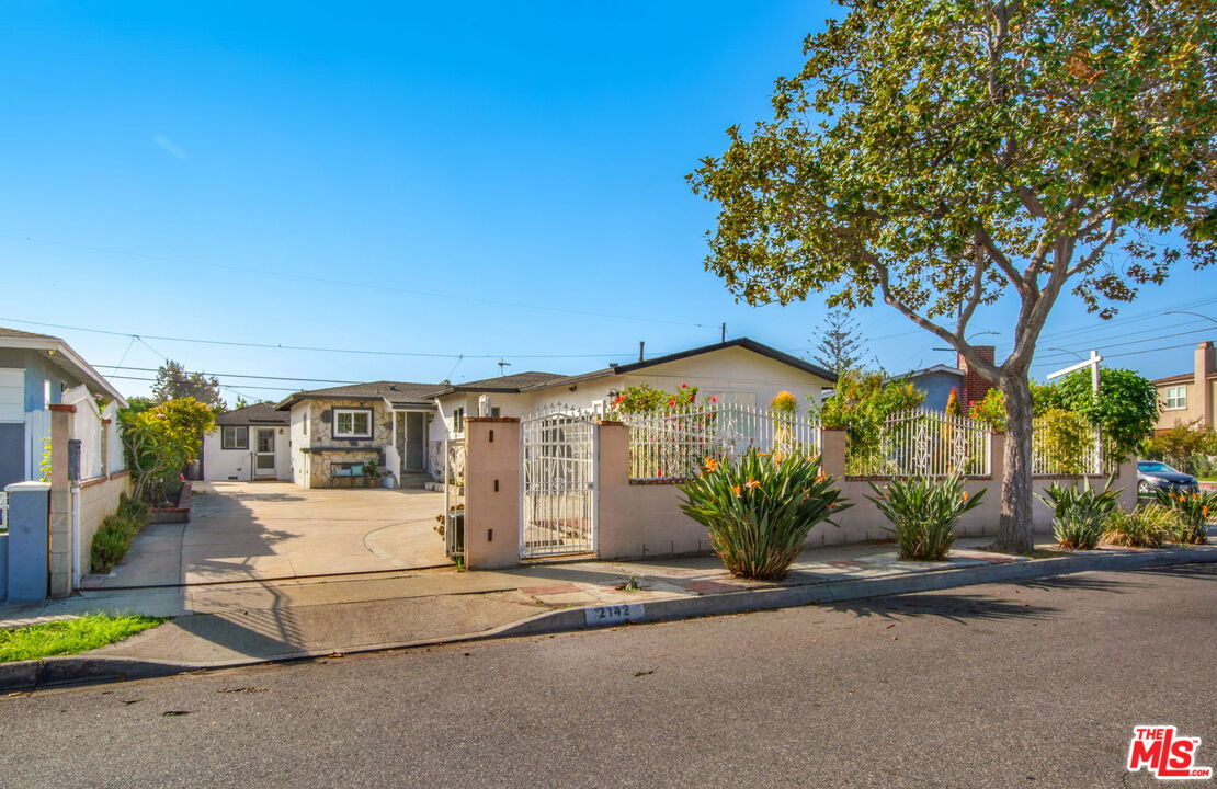2142 West 11th Street Santa Ana, CA 92703 - Photo 1 of 54 a front view of a house with a yard and garage