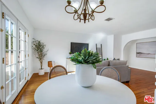 a view of a kitchen area with furniture and wooden floor