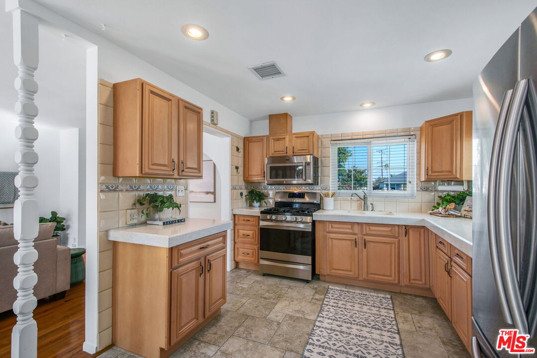 2142 West 11th Street Santa Ana, CA 92703 - Photo 15 of 54 a kitchen with a sink stove and cabinets