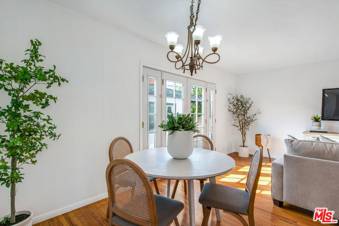 2142 West 11th Street Santa Ana, CA 92703 - Photo 17 of 54 a view of a dining room with furniture wooden floor and chandelier