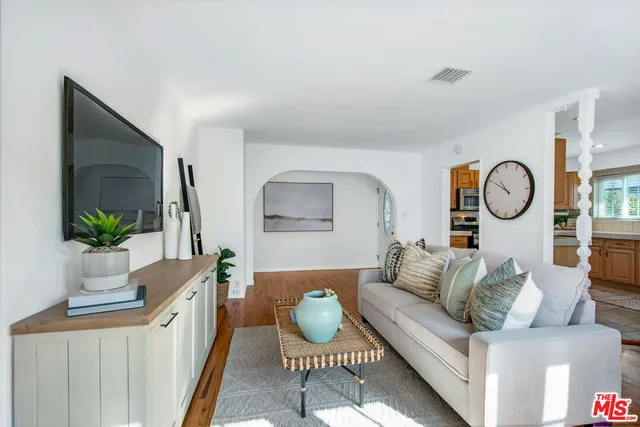 an empty room with wooden floor and mirror