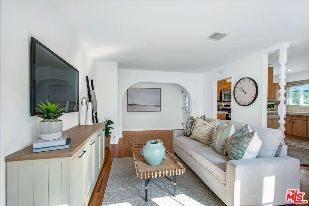 2142 West 11th Street Santa Ana, CA 92703 - Photo 19 of 54 a living room with furniture a mirror and a flat screen tv