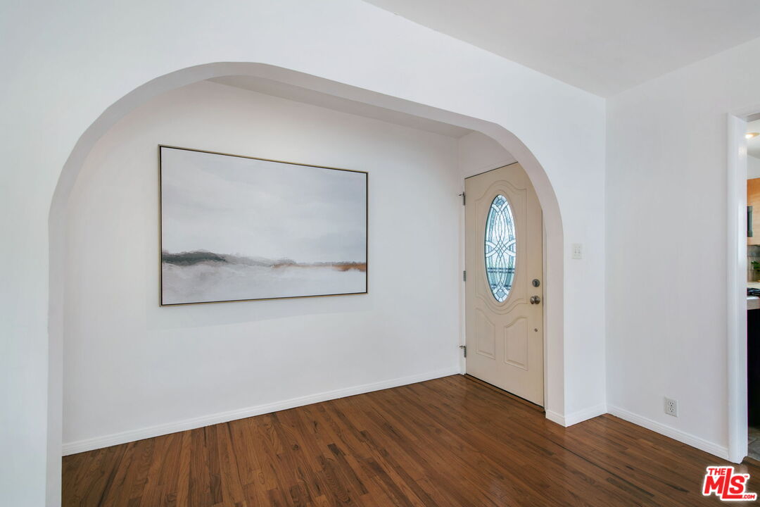 2142 West 11th Street Santa Ana, CA 92703 - Photo 21 of 54 an empty room with wooden floor and mirror