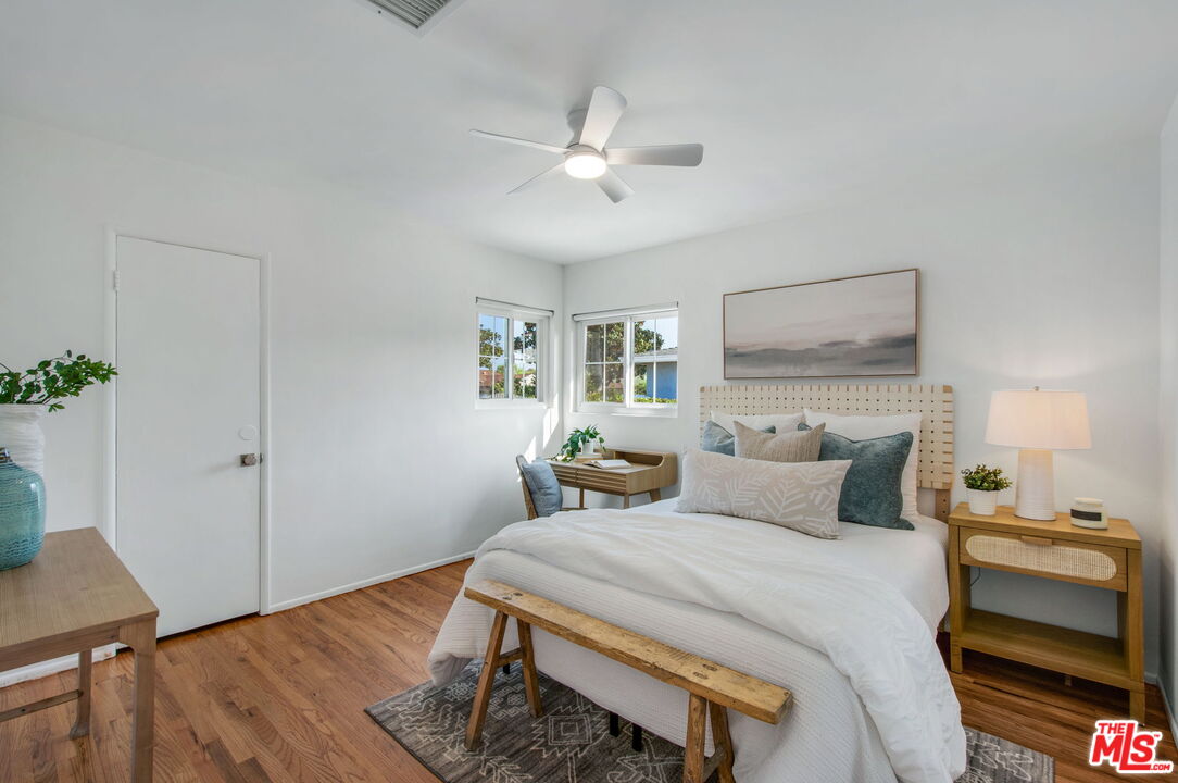 2142 West 11th Street Santa Ana, CA 92703 - Photo 25 of 54 a bedroom with a bed and wooden floor