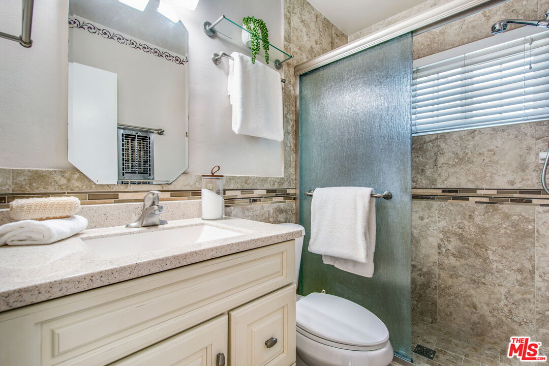 2142 West 11th Street Santa Ana, CA 92703 - Photo 26 of 54 a bathroom with a sink toilet vanity and shower