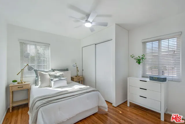 a kitchen with stainless steel appliances a sink a stove a window cabinets and a dining table