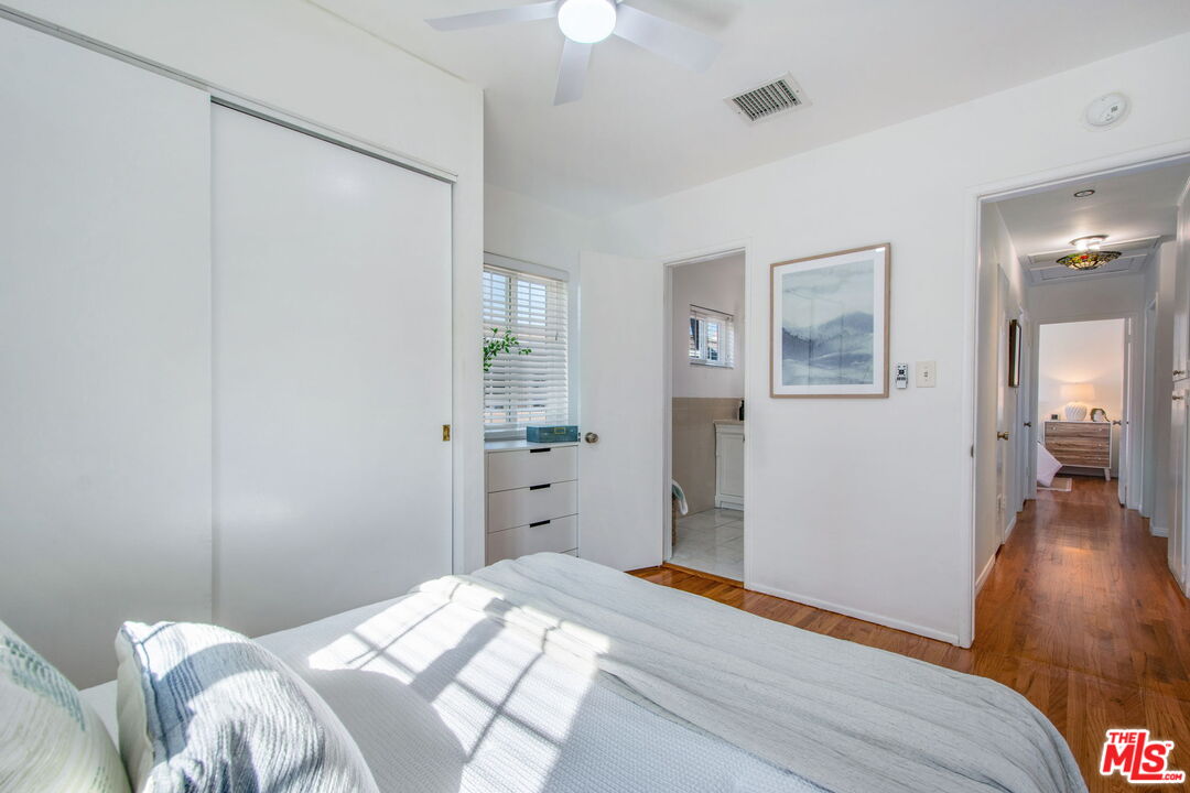 2142 West 11th Street Santa Ana, CA 92703 - Photo 30 of 54 a bedroom with a bed and a chandelier