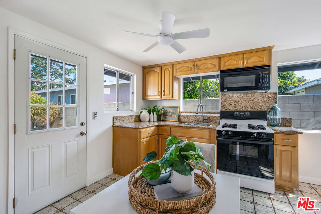2142 West 11th Street Santa Ana, CA 92703 - Photo 34 of 54 a kitchen with stainless steel appliances granite countertop a stove a sink and a refrigerator
