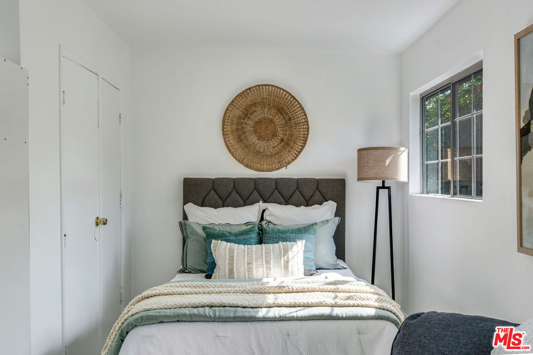 2142 West 11th Street Santa Ana, CA 92703 - Photo 40 of 54 a bedroom with a bed and a painting on the wall