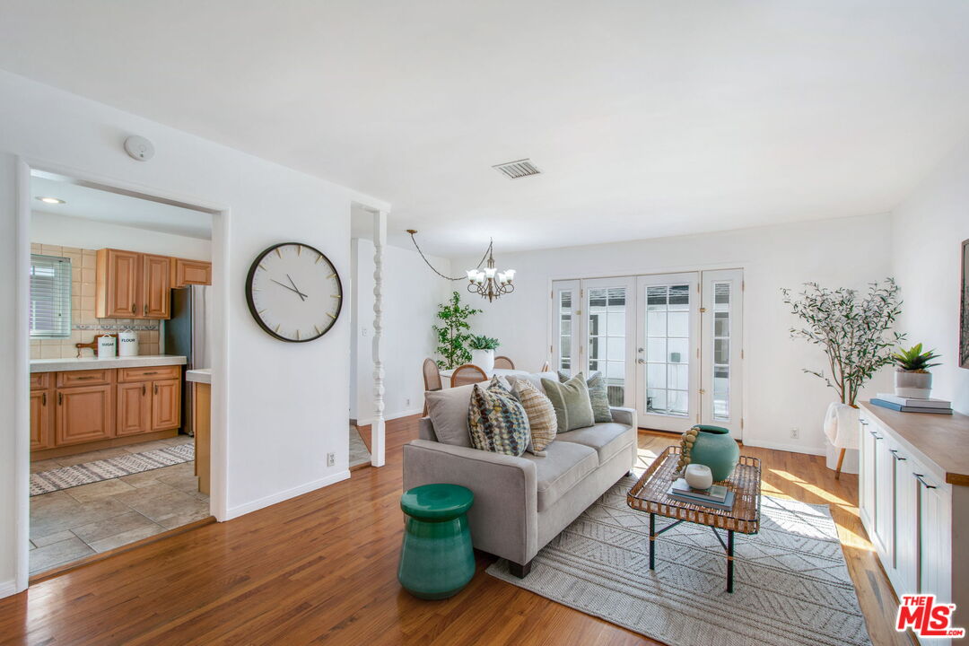 2142 West 11th Street Santa Ana, CA 92703 - Photo 4 of 54 a living room with furniture a rug and a mirror