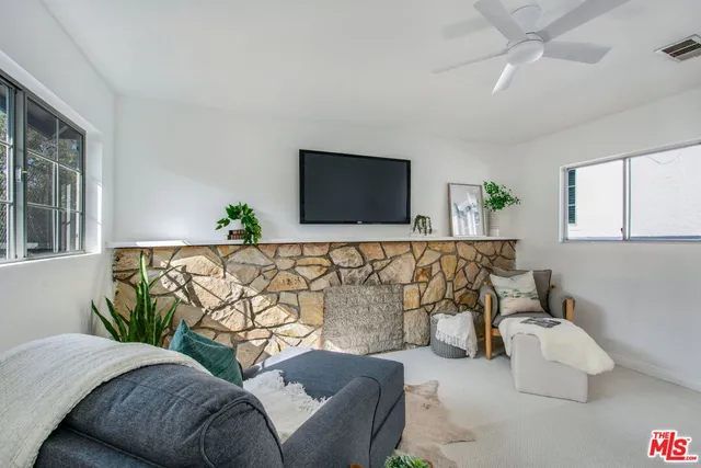 a view of a house with backyard and trees