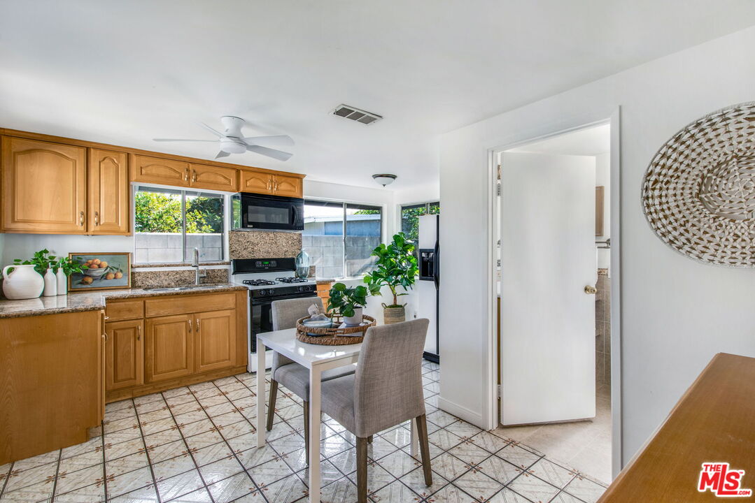 2142 West 11th Street Santa Ana, CA 92703 - Photo 43 of 54 a kitchen with a refrigerator and a stove top oven